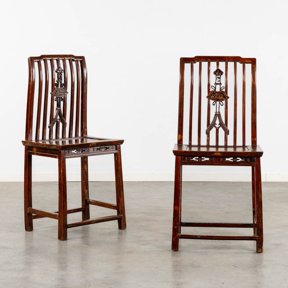 A pair of antique Chinese sculptured chairs with a high back. (L:39 x W:50 x H:106 cm) (L:50 x W:39 x H:106 cm)