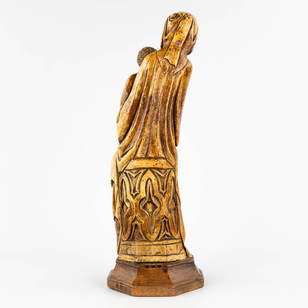 A 'Madonna with Child', sculptured Ivory in gothic revival style, 19th C. (D:18 x W:18 x H:54 cm)