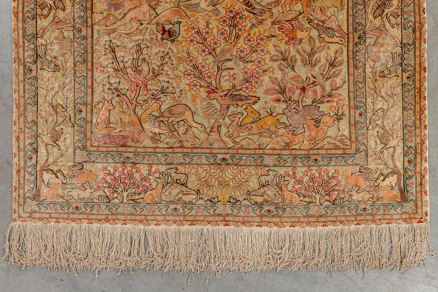 An Oriental hand-made carpet, decorated with fauna and flora. Hereke. (D:144 x W:108 cm)