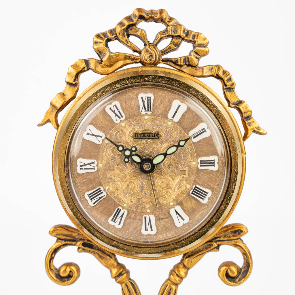 A three-piece garniture clock made of bronze and porcelain. (H:21,5cm)