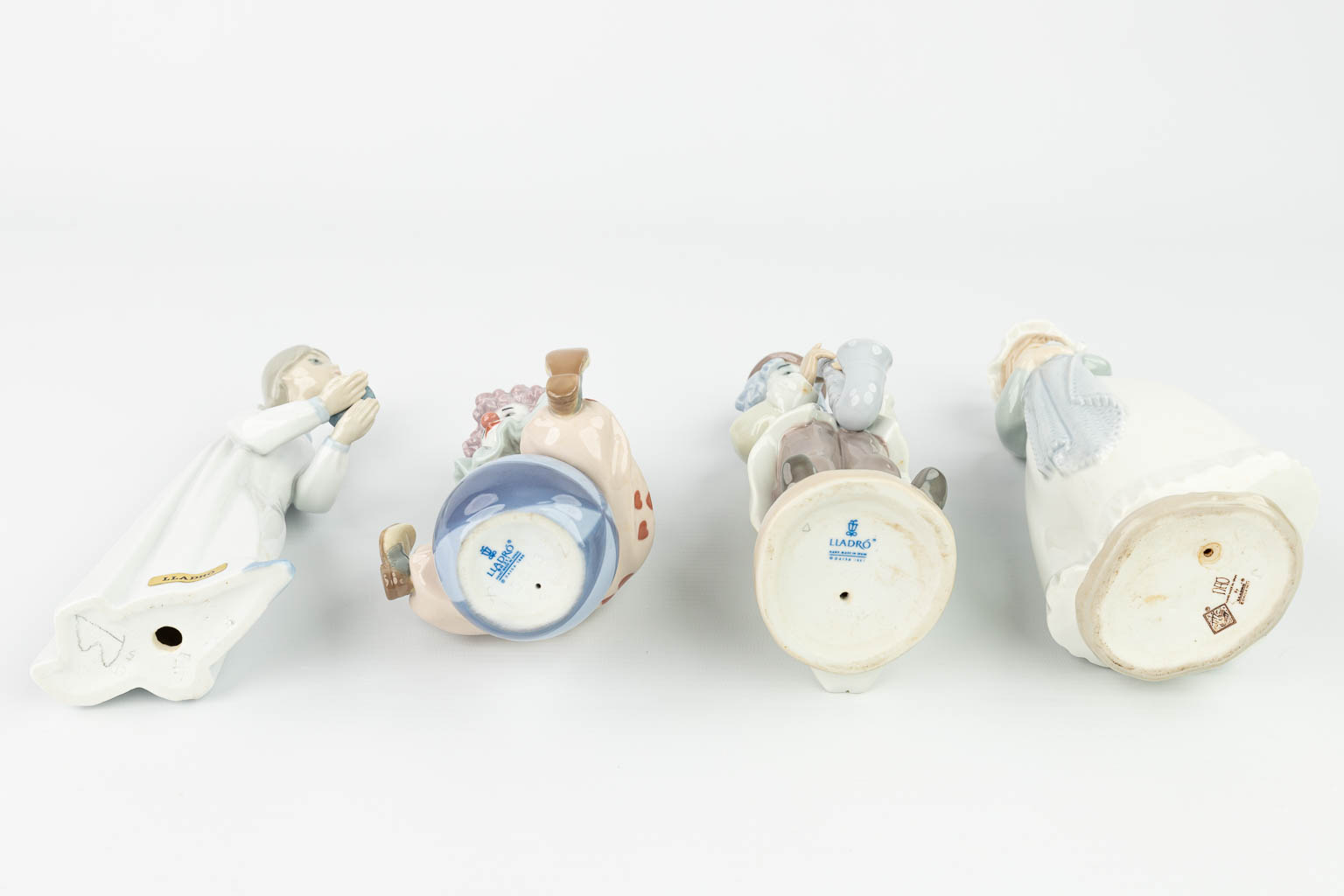 A collection of 4 figurines made of porcelain in Spain and marked Lladro. (H:24cm)