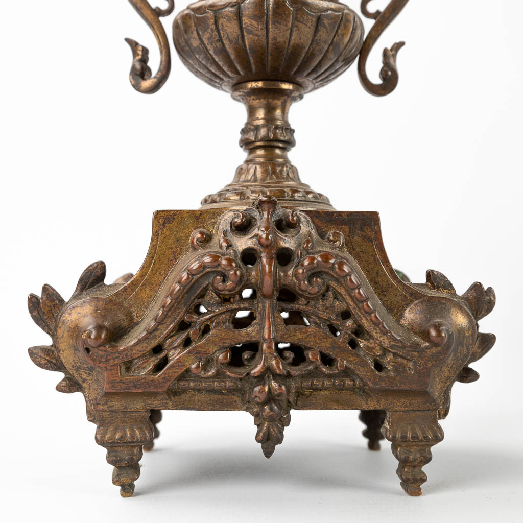 A three-piece mantle garniture clock and candelabra, patinated bronze. Circa 1900. (D:11 x W:22 x H:43 cm)