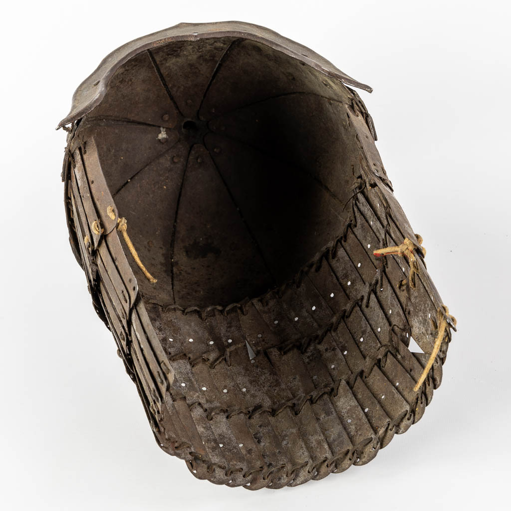 A Tibetan military helmet, iron and leather. 18th/19th C. (L:20 x W:24 x H:42 cm)