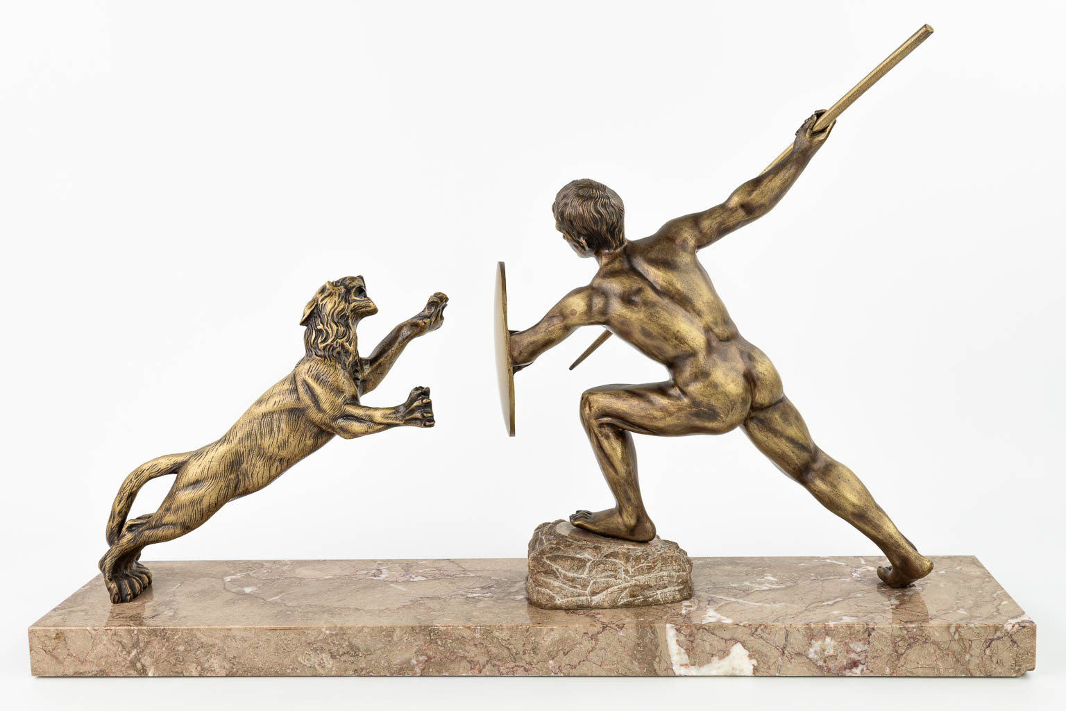 R. TUBACK (XIX-XX) 'Hunter with lion' an art deco statue made of bronze and mounted on a marble base. (H:46cm)