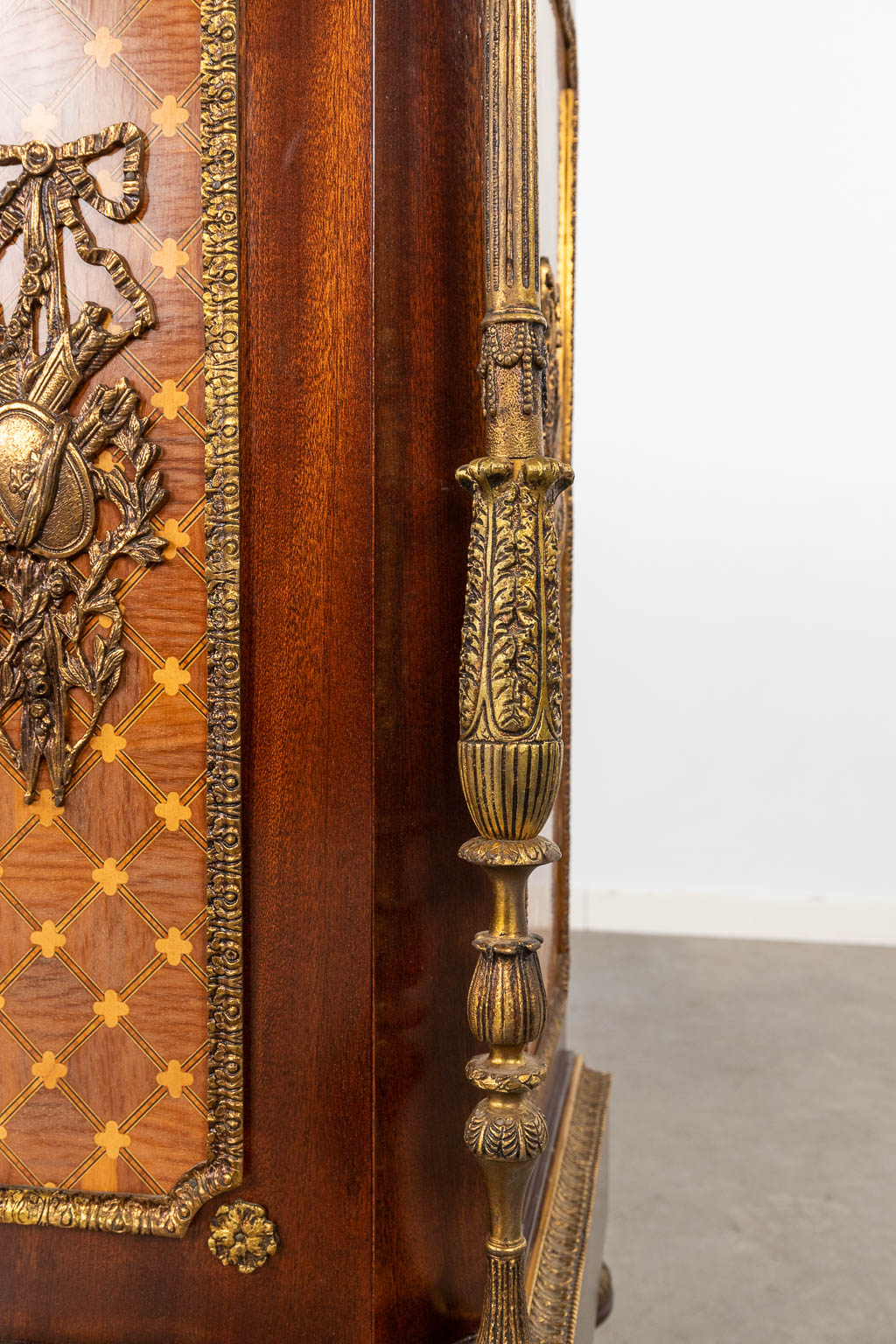 A cabinet, wood veneer mounted with bronze in Louis XVI style with a marble top. 20th C. (D:44 x W:120 x H:106 cm)