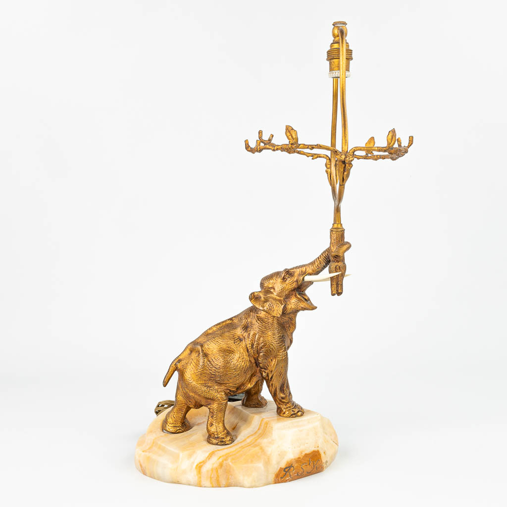 A table lamp 'Elephant figurine' made of gilt bronze with tusks, mounted on an onyx base and singed R. St. Yves. (H:46