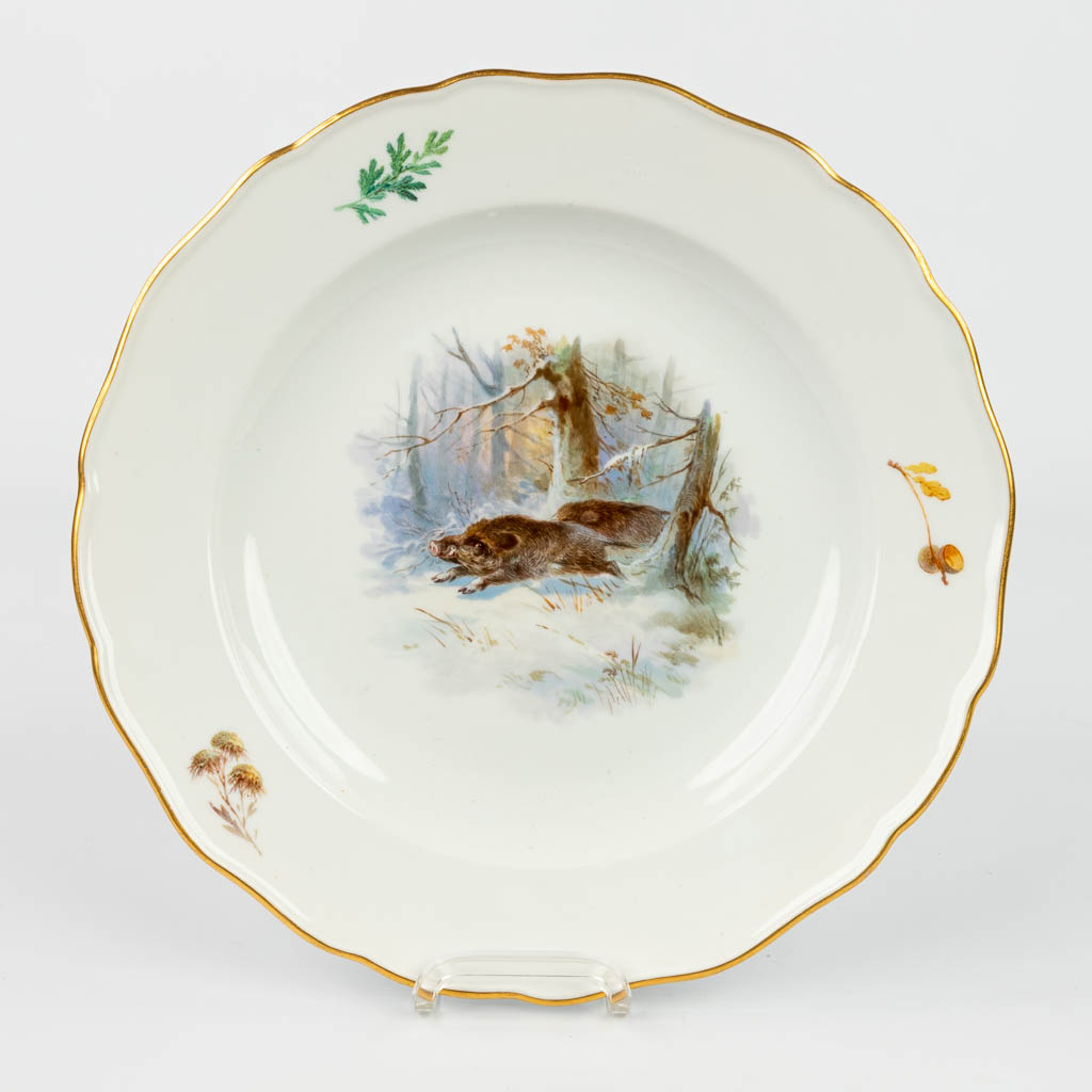 A set of 8 plates with hand-painted images of wild animals and marked with crossed swords, marked Meissen. 