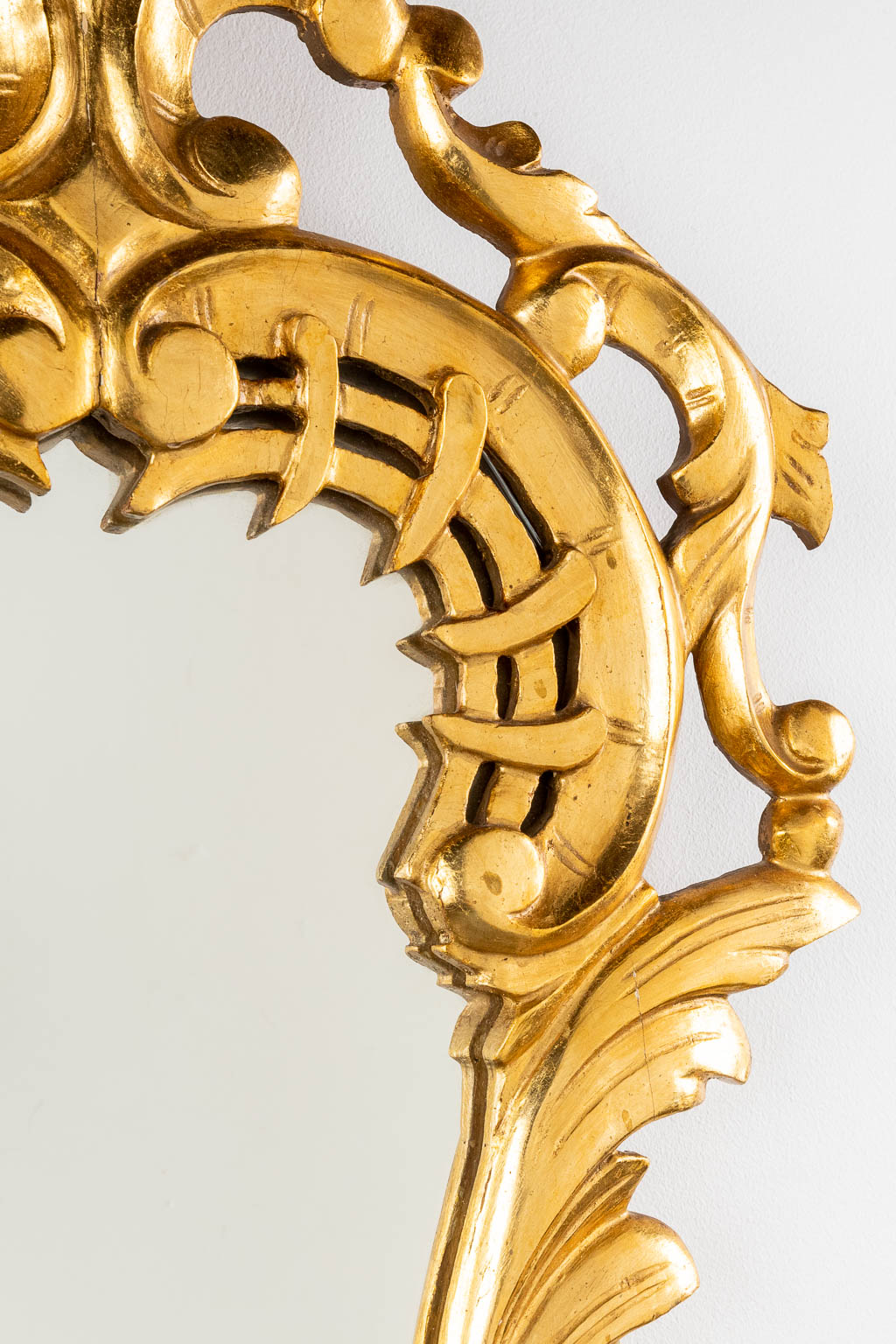 An antique mirror, sculptured and gilt wood, Roccoco style. Circa 1900. (W:42 x H:82 cm)