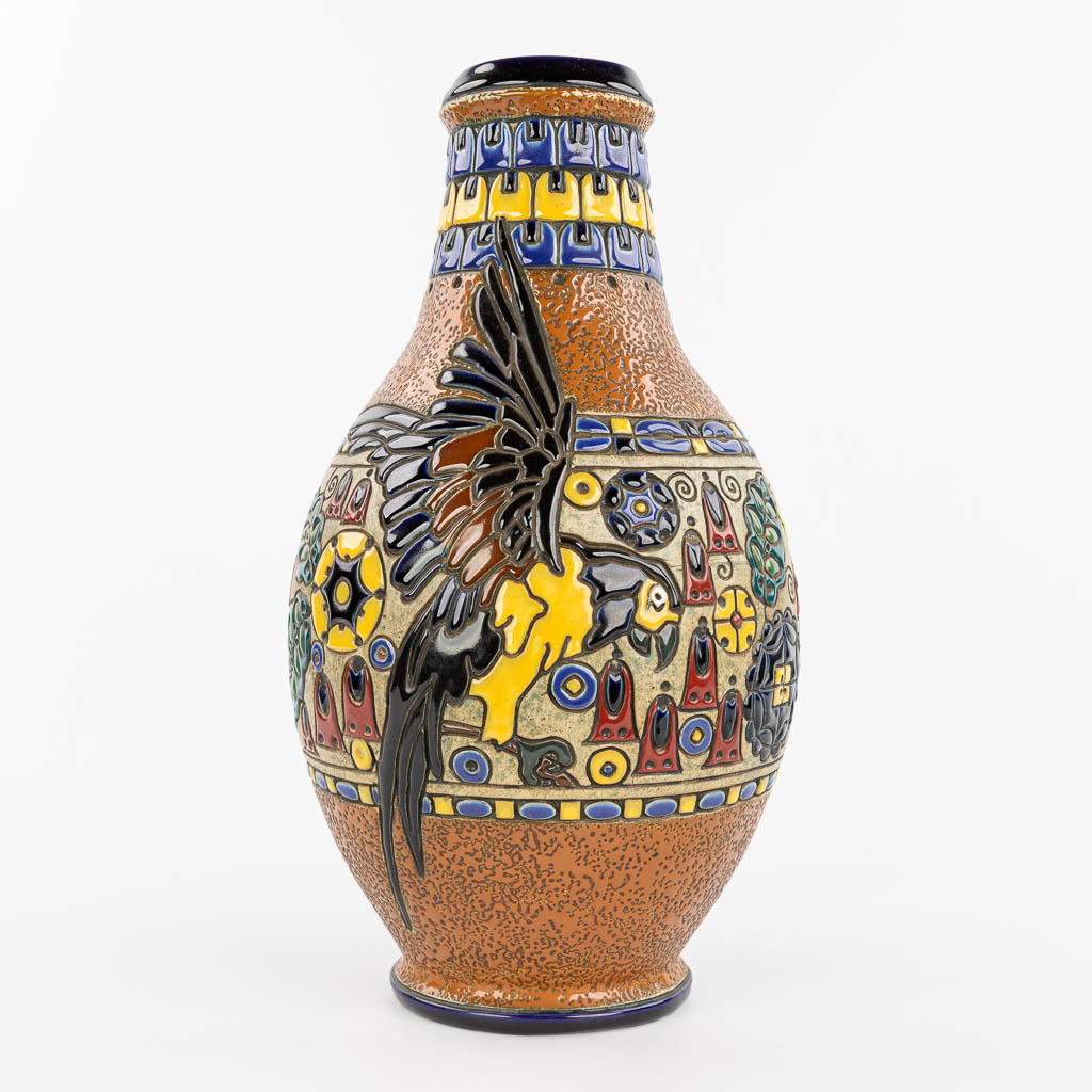 A vase made of glazed faience and decorated with an ara parrot, marked Amphora Teplitz. (H:45cm)