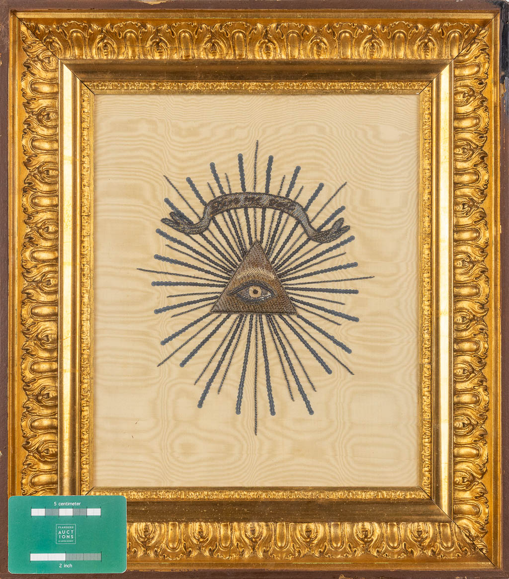 A framed embroidery, 'Dieu Me Voit', The Eye Of Providence. (W:37 x H:42 cm)