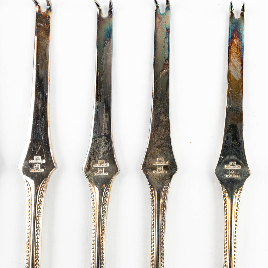 A collection of lobster forks made of silver-plated metal by Christofle, model Perles. 