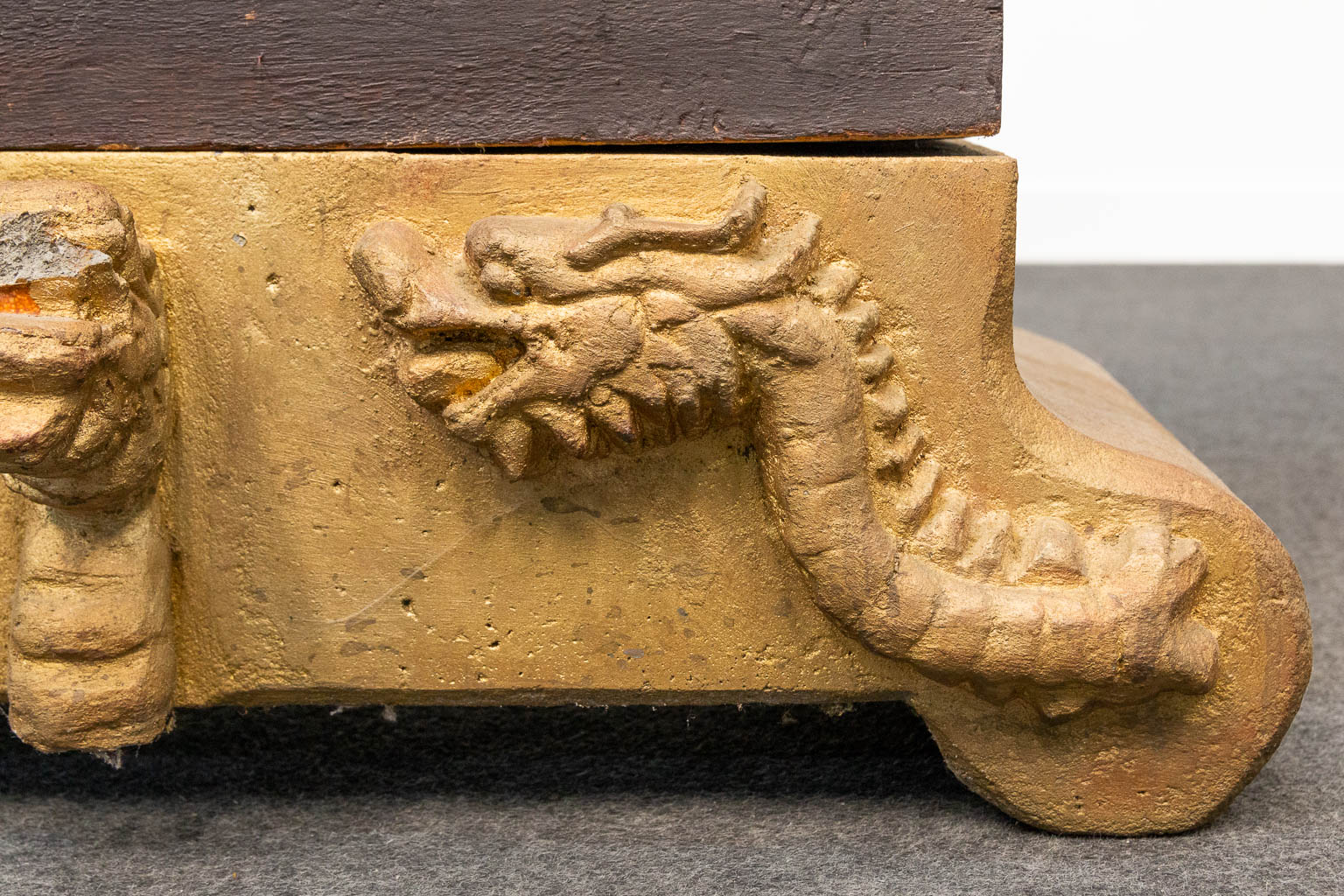 A Xylophone made of sculptured wood in the shape of a dragon and standing on a stone base. Indonesia, 20th century. (H:138cm)