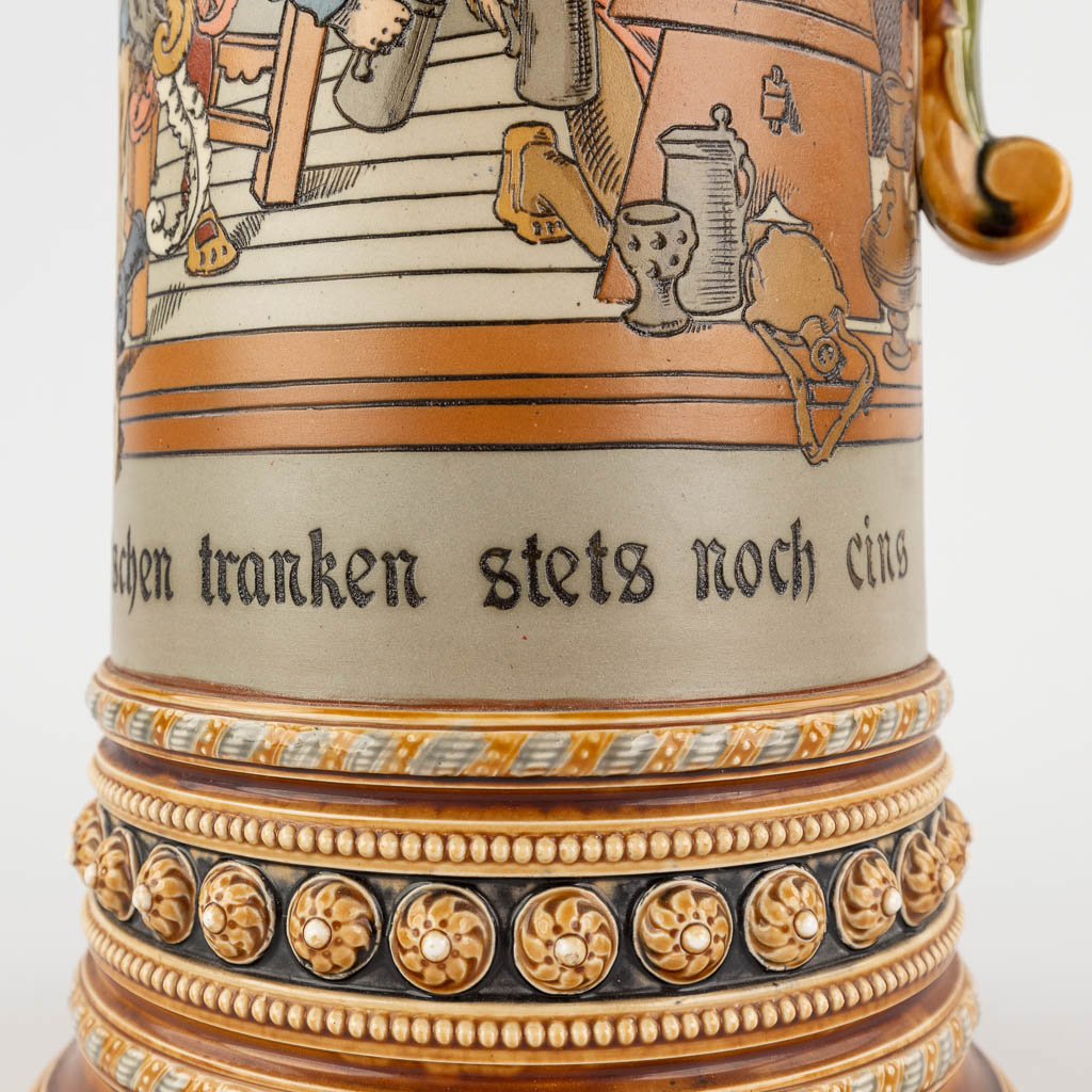 Mettlach, a large beer pitcher with polychrome decor, grès. Germany, 20th C. (D:18 x W:21 x H:51 cm)