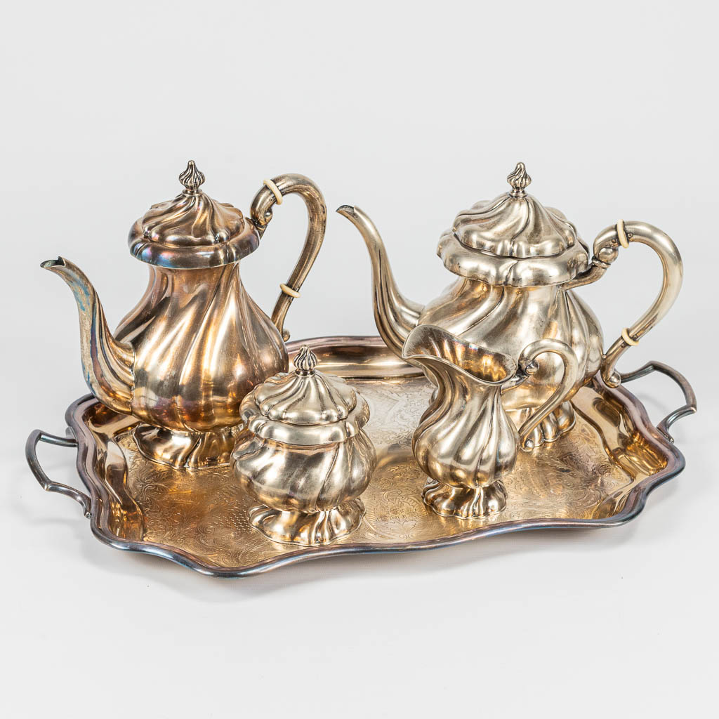 A 4-piece coffee and tea service made of silver on a silver-plated tray. 