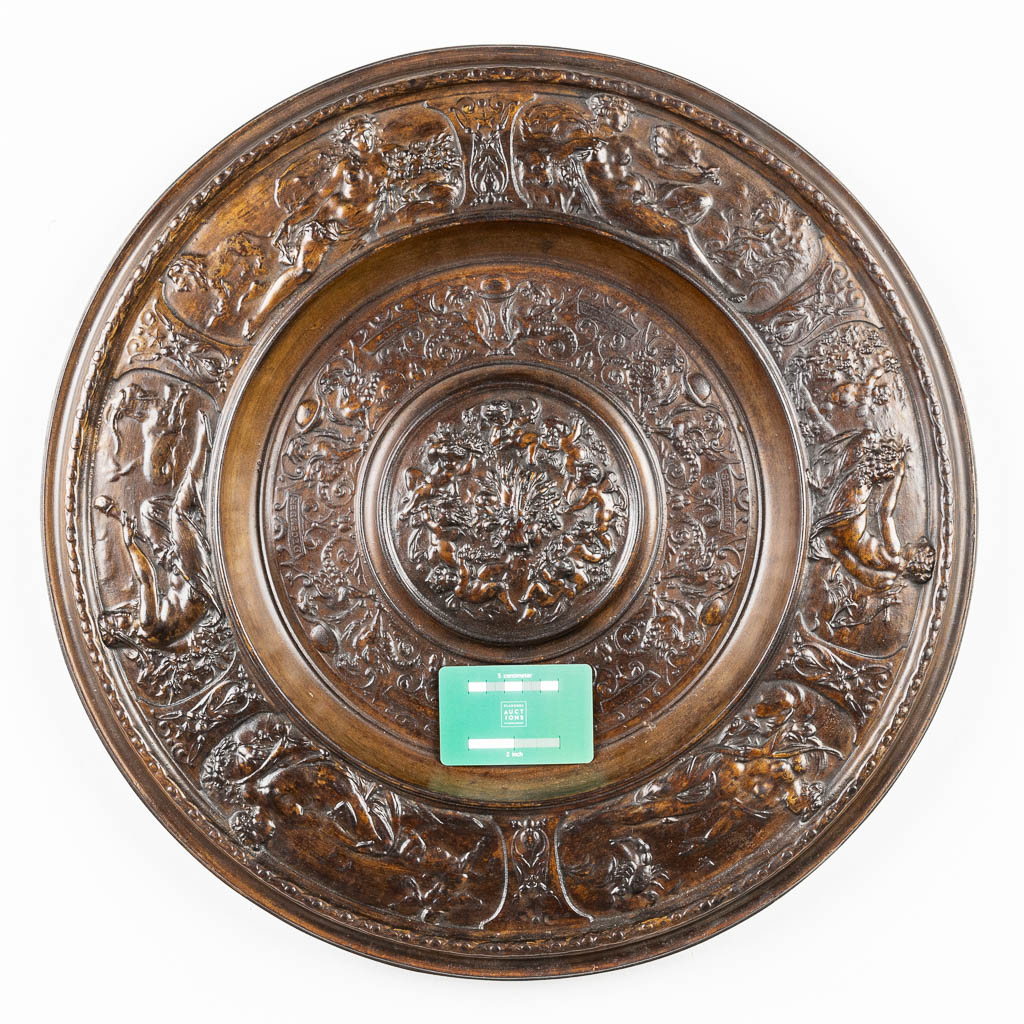 A large and decorative plate made of cast iron. 
