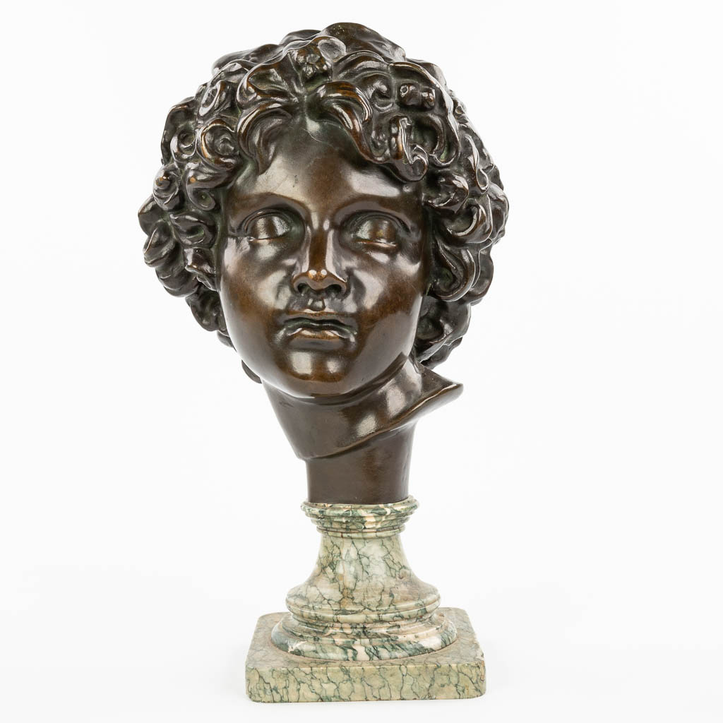 A bronze head of a young man, mounted on a marble base. Marked Peterman, Brussels. (H:40cm)
