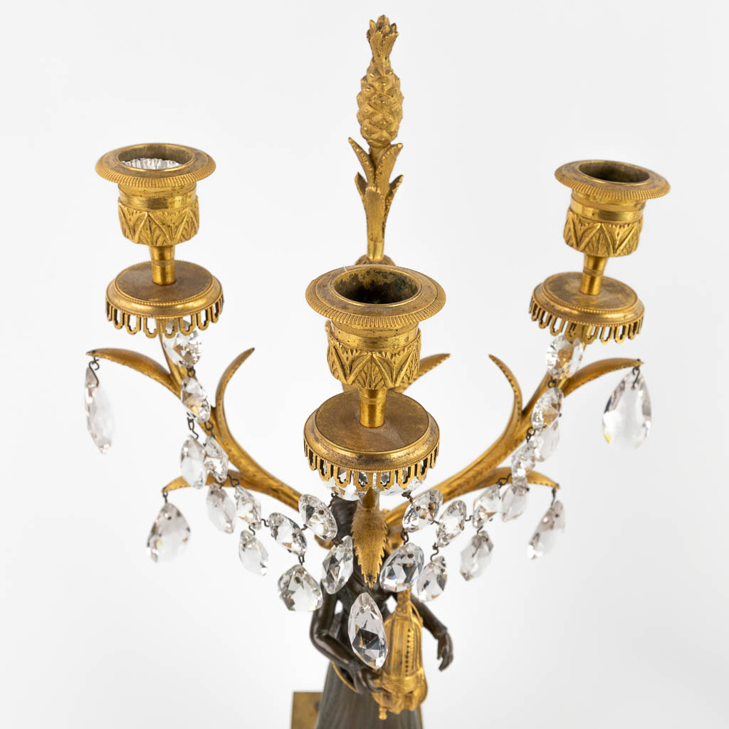 A pair of candelabra, gilt and patinated bronze, Empire, 19th C. (D:15 x W:24 x H:53 cm)