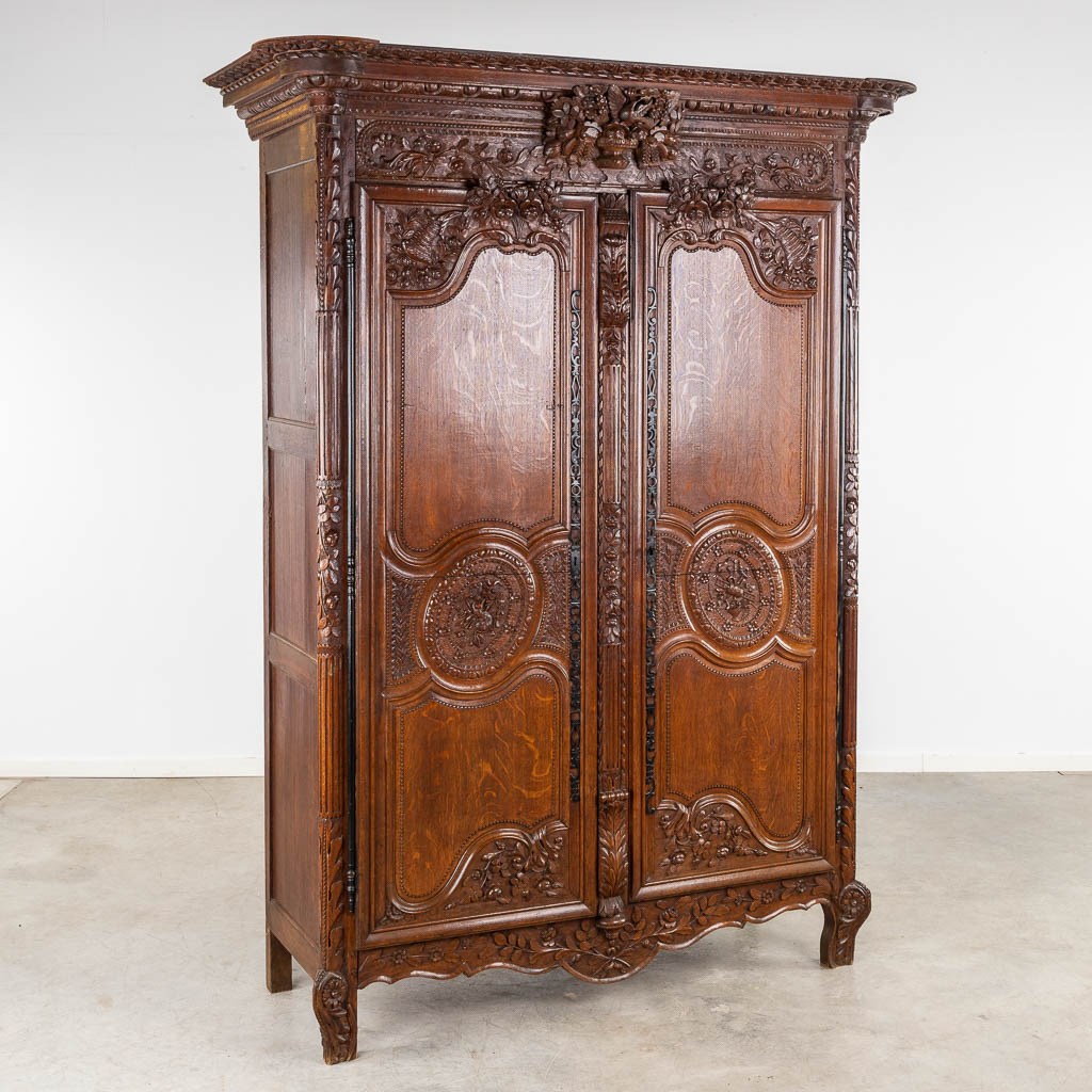  A richly sculptured and antique Normandy high cabinet, Armoire. France, 18th C.