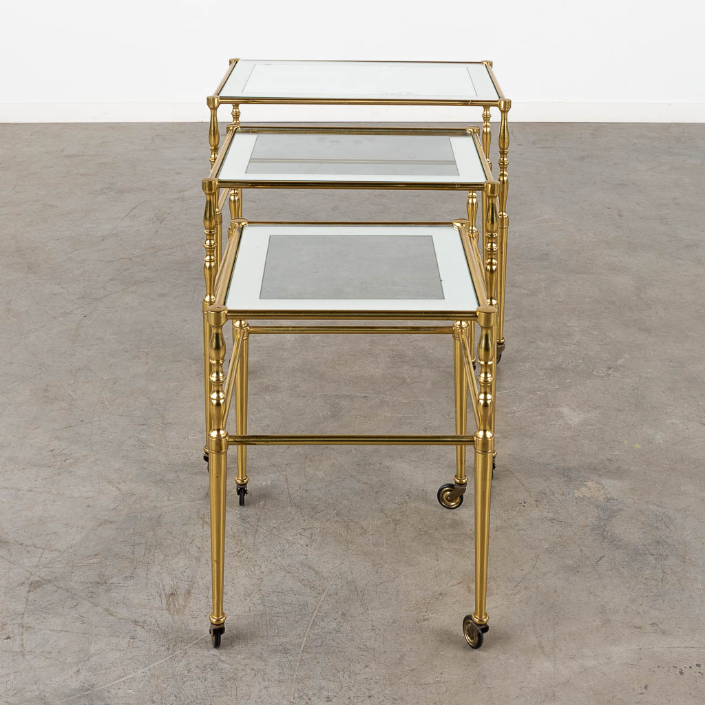 A set of nesting tables, brass and glass. 20th C. (D:39 x W:56 x H:52 cm)