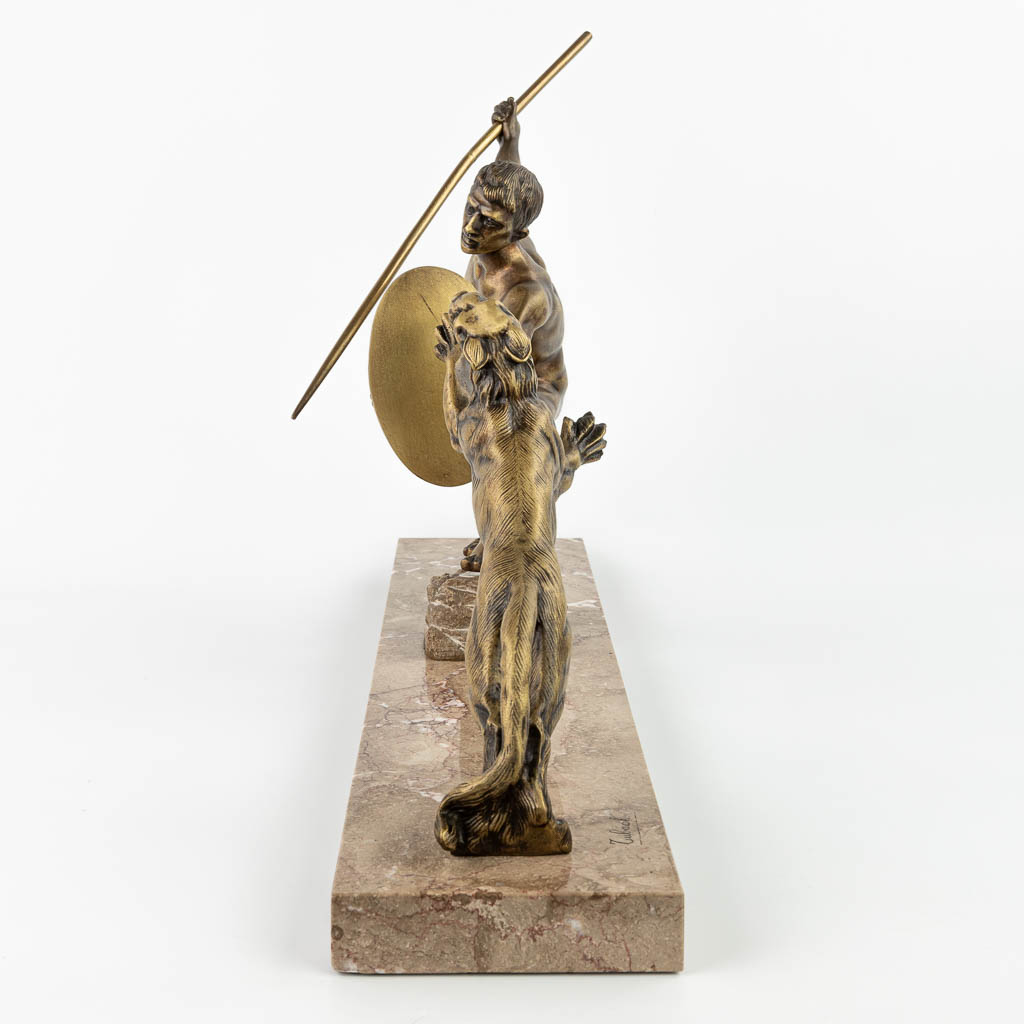 R. TUBACK (XIX-XX) 'Hunter with lion' an art deco statue made of bronze and mounted on a marble base. (H:46cm)