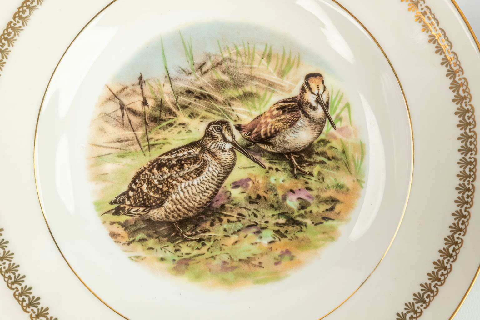 A 30-piece dinner service decorated with wildlife, made of porcelain and marked Porcelain de Limoges. (H:16,5cm)