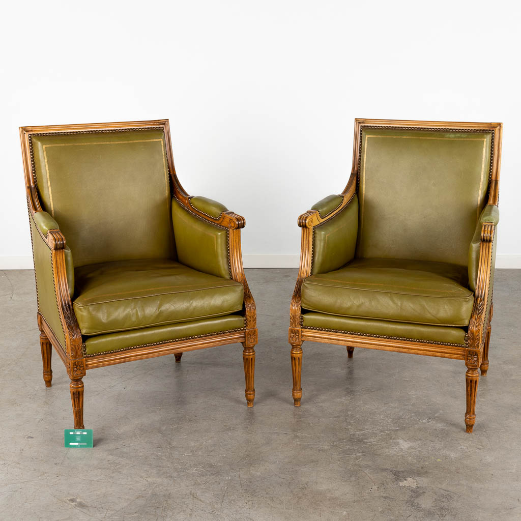 A pair of Louis XVI style armchairs, wood and olive green leather. Circa 1970. (D:61 x W:60 x H:90 cm)