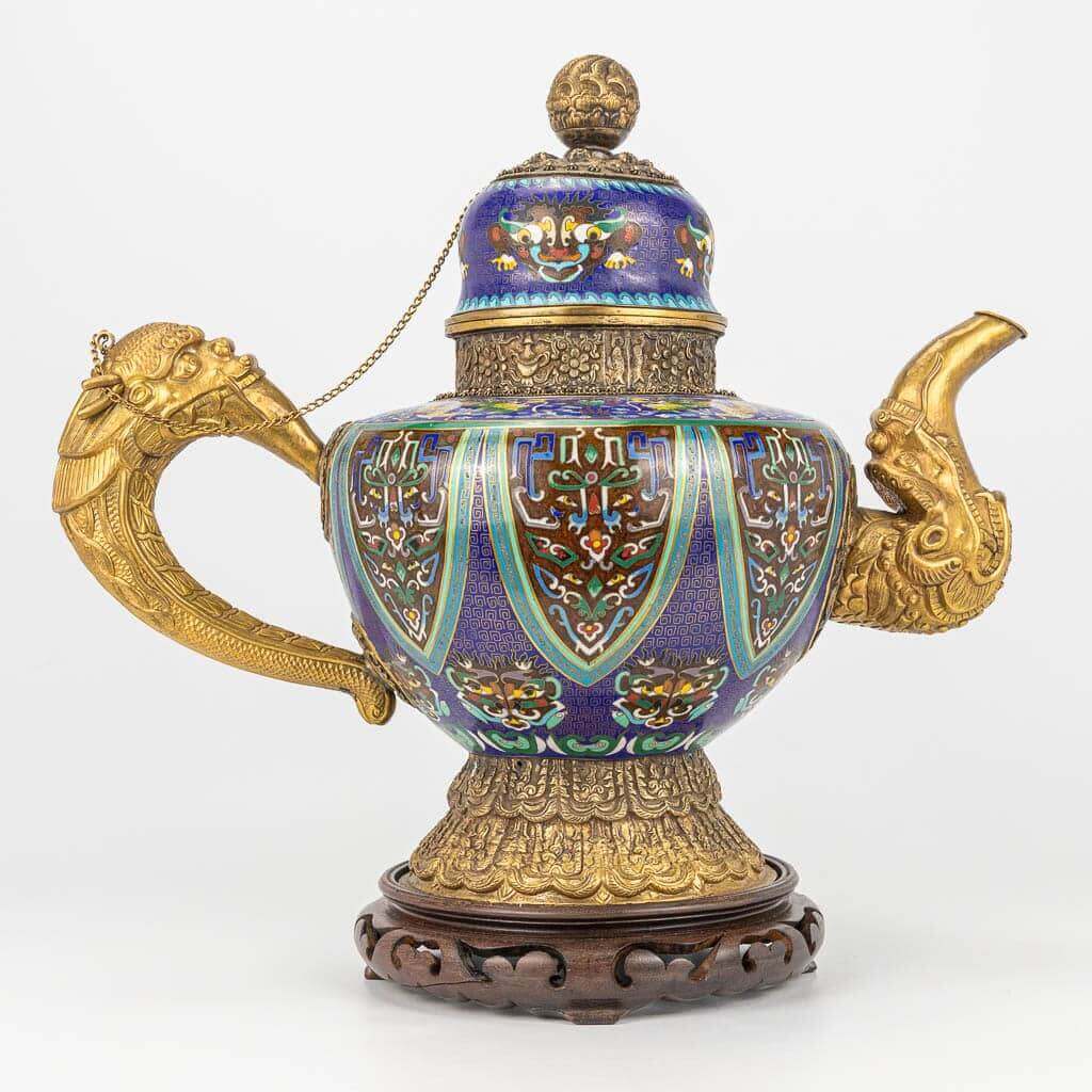 A Tibetan ceremonial ewer made of gilt bronze and finished with cloisonné bronze.