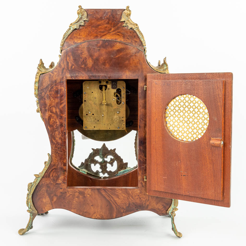 A Kartell clock mounted with bronze and finished with marquetry inlay. (H:79cm)