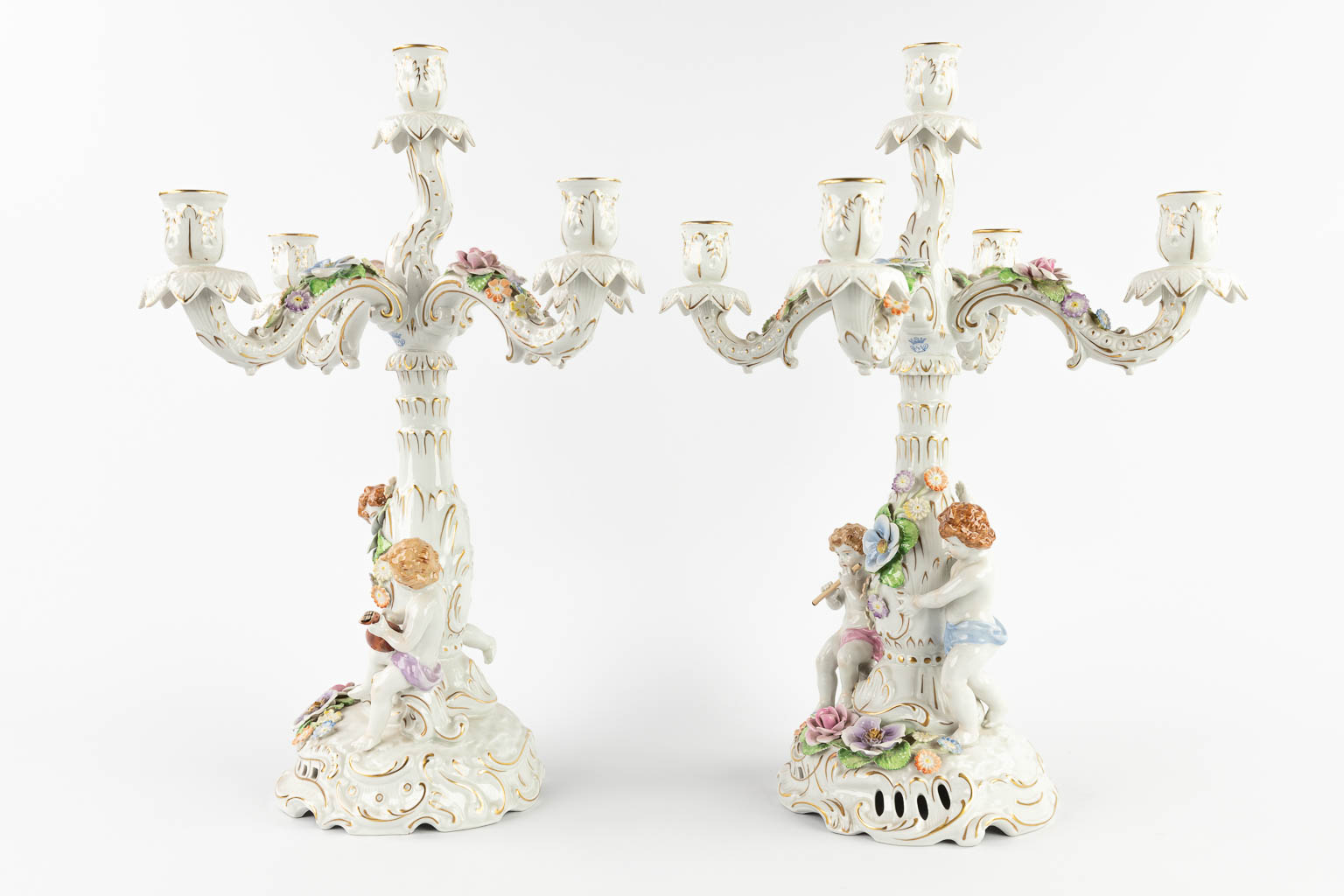 A pair of candelabra, polychrome porcelain decorated with figurines. Marked PMP, 20th C. (D:37 x W:37 x H:49 cm)