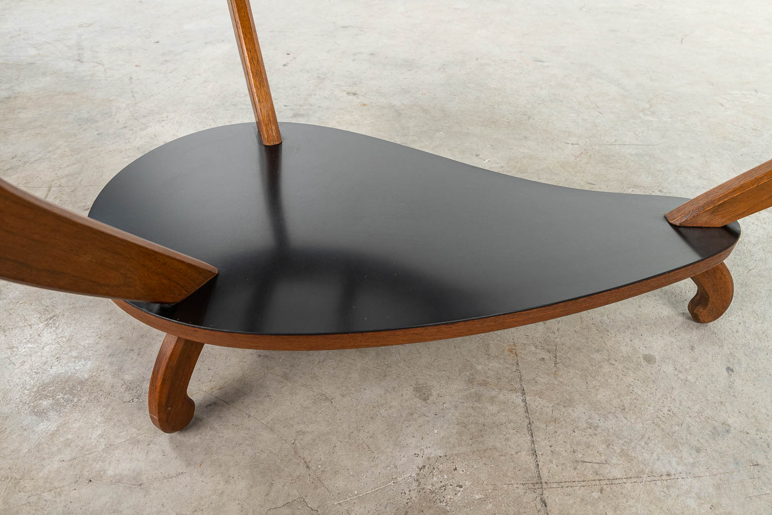 A mid-century coffee table made of wood and glass. 