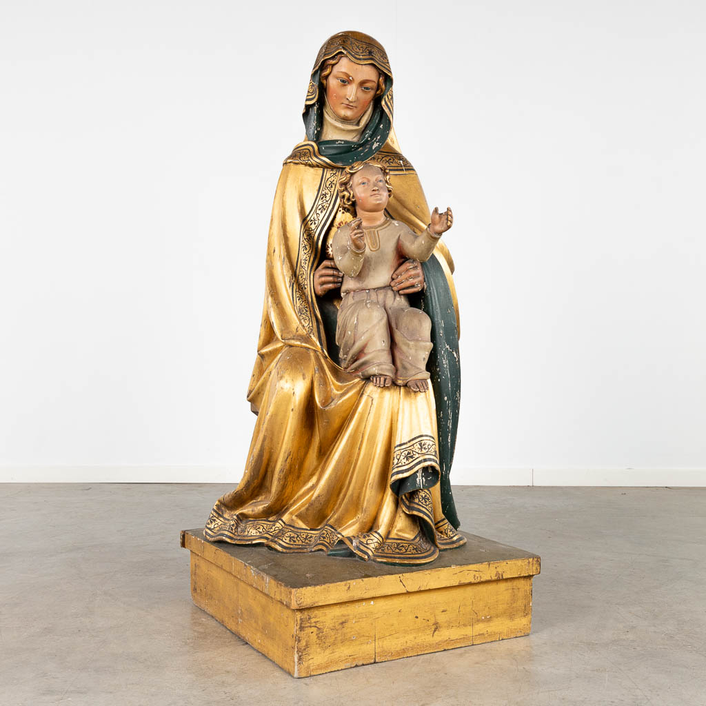 An antique wood-sculptured statue of Saint Anna with child, gilt and polychrome. 18th/19th C. (D:51 x W:58 x H:118 cm)
