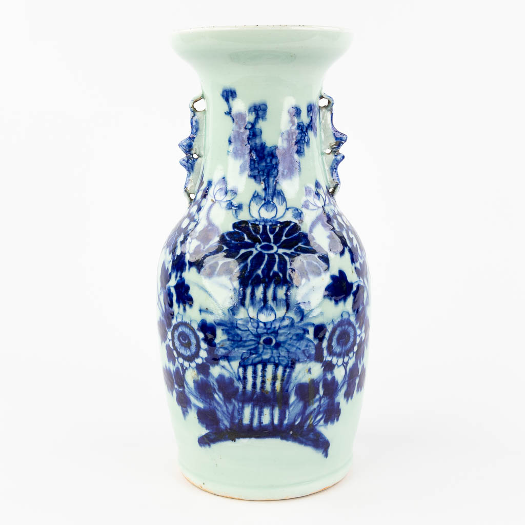  A Chinese vase with blue-white flower decor and celadon glaze. 19th/20th C. 