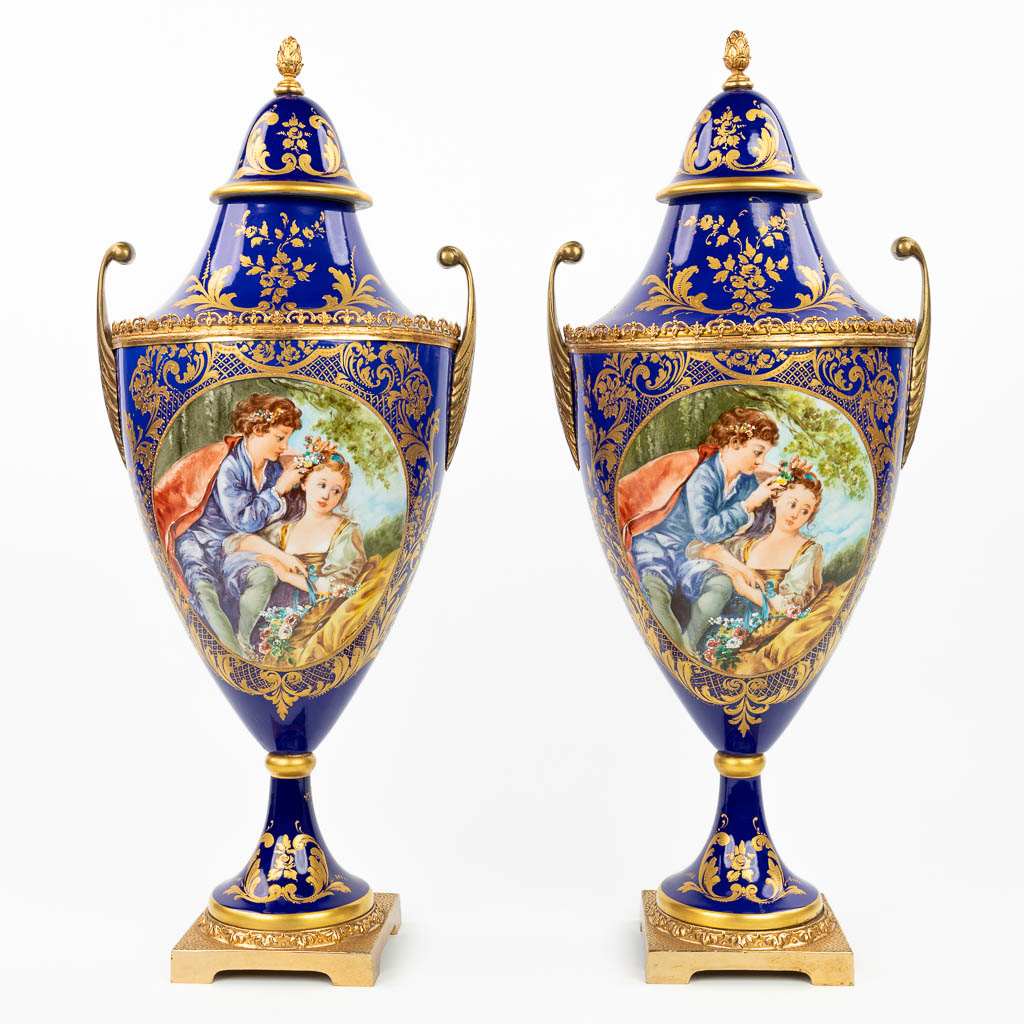 A pair of vases with a hand-painted decor in sèvres style. Marked S. Mannoli. (H:58cm)