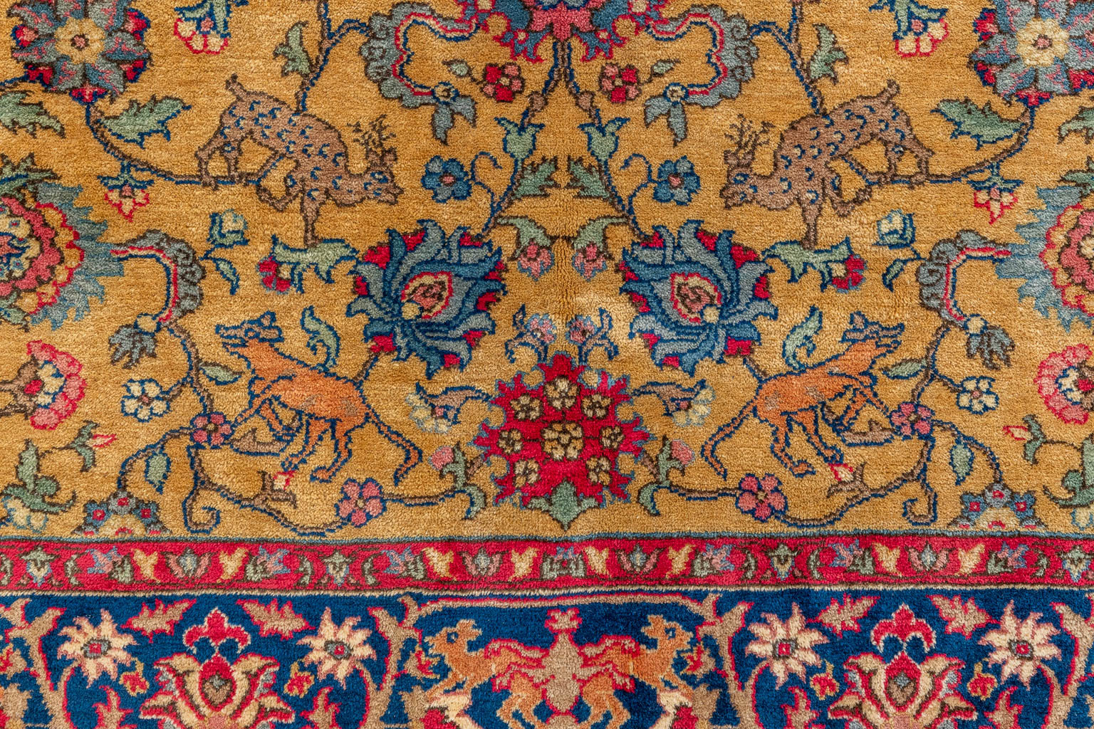 An Antique Oriental hand-made carpet decorated with animals, Kashan. (D:253 x W:153 cm)