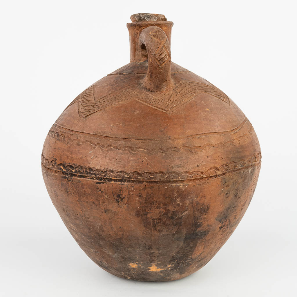 An antique jug with the original stopper made of terracotta finished with sgraffito decor. (H:32cm)