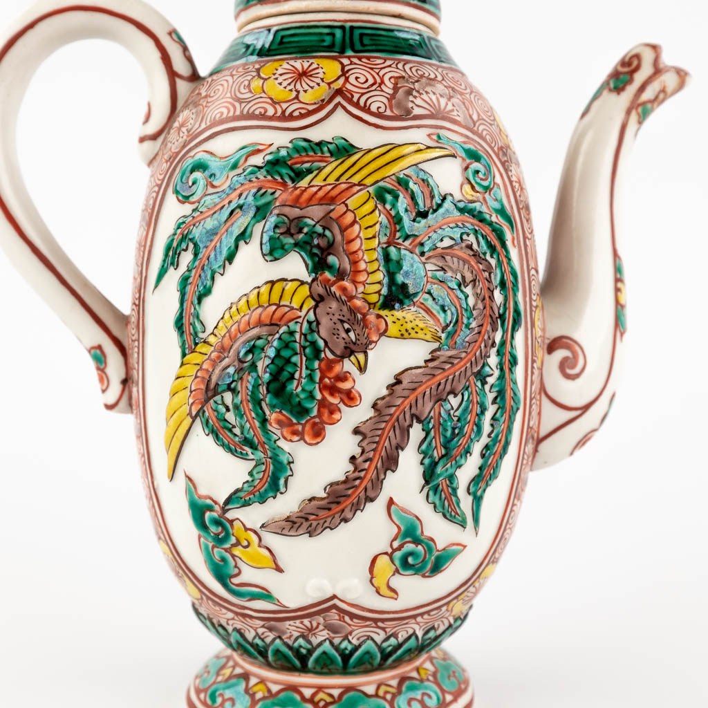 A teapot with a Famille Verte relief decor, probably Chinese export for the middle eastern market. 19th/20th C. (W:15 x H:18 cm)