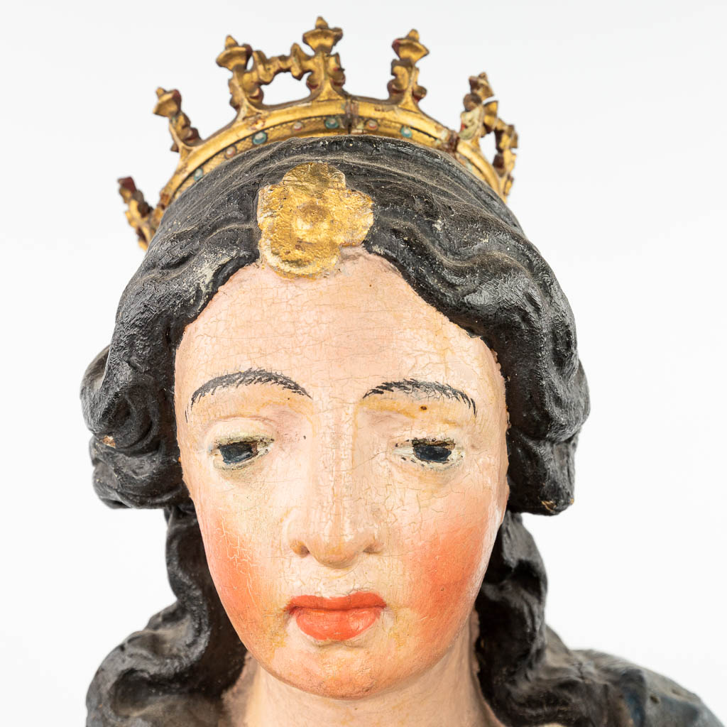 A patinated wood statue of Madonna with a child, standing on the serpent and half-moon. (H: 90 cm)