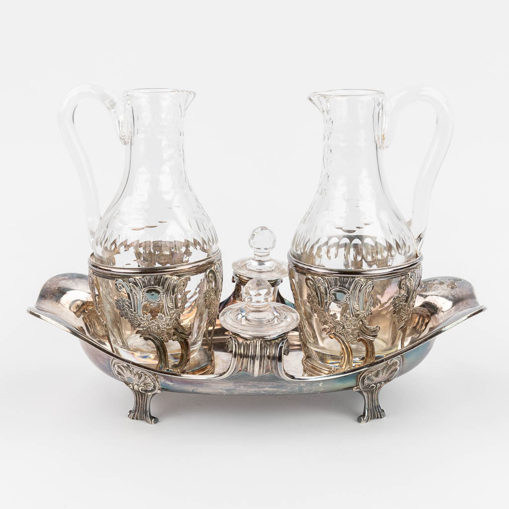 An antique oil and vinegar set, made of cut crystal and silver. Circa 1850.  (L:26 x W:16 x H:21 cm)