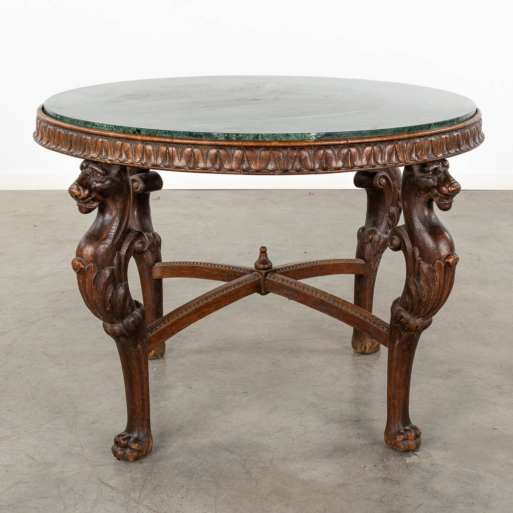 A wood-sculptured coffee table, mythological figurines and a green marble top. 20th C. (D:93 x W:93 x H:63 cm)