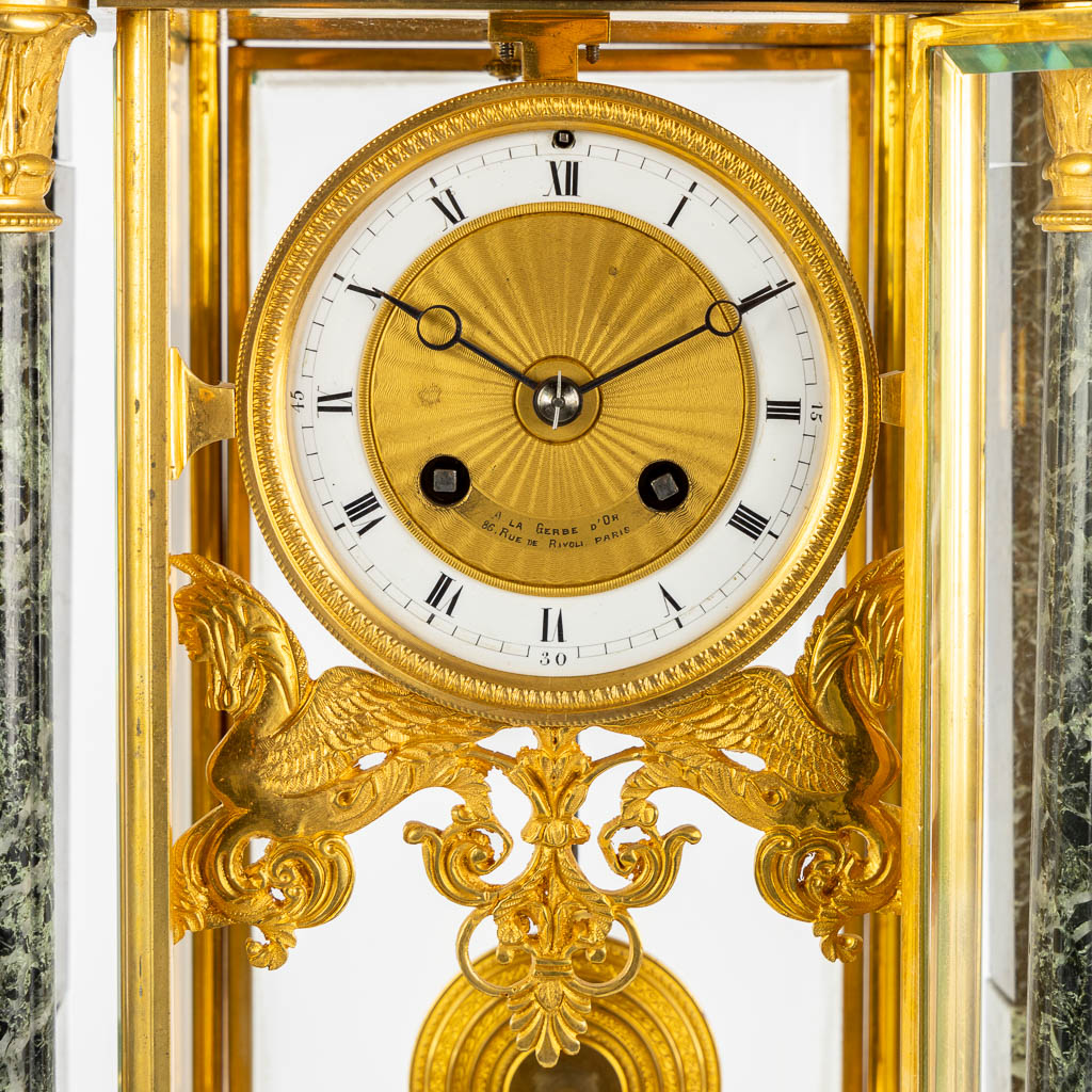 A three-piece mantle garniture clock and urns, gilt bronze on green marble, Empire style. France, 19th C. (L:16,5 x W:37 x H:51 
