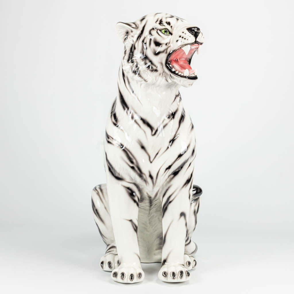 A ceramic statue of a white tiger with black stripes. Made in Italy. 