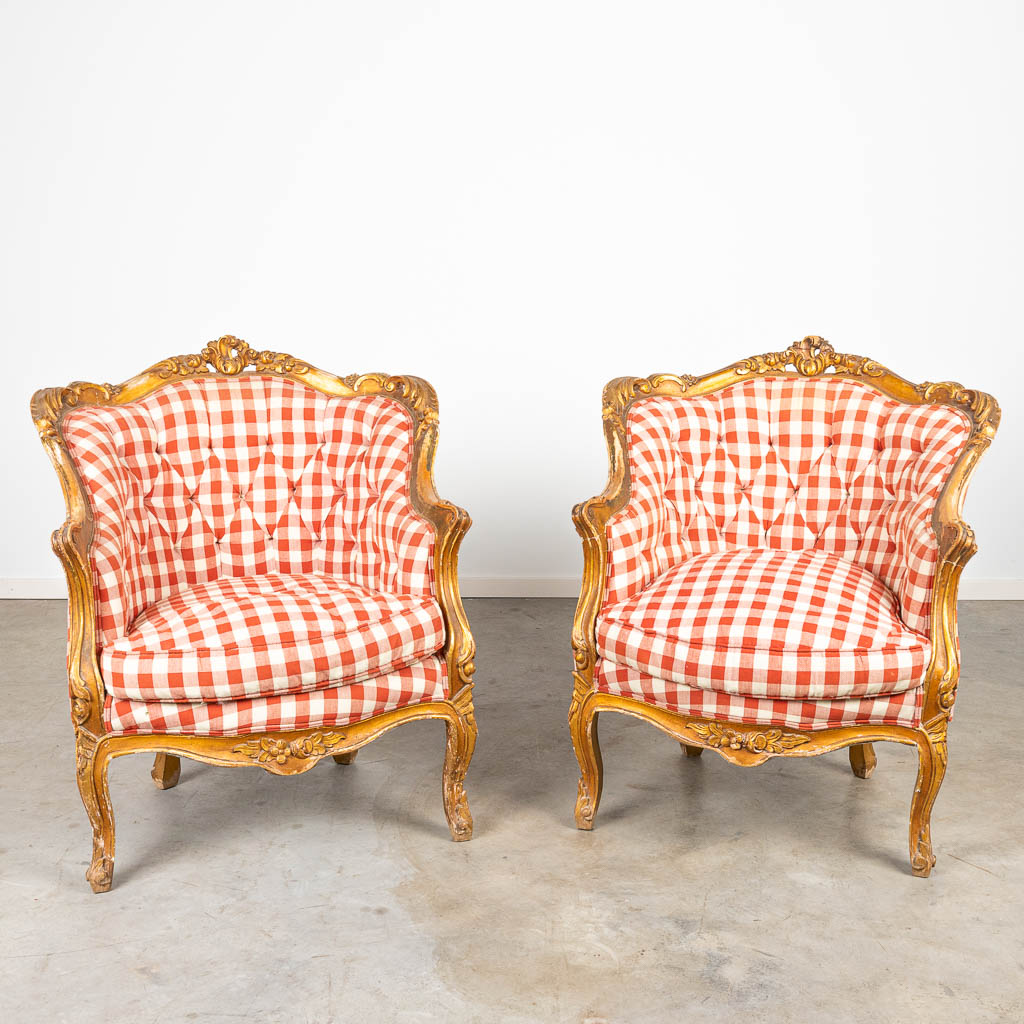 A pair of armchairs made of gilt sculptured wood in Louis XV style. 