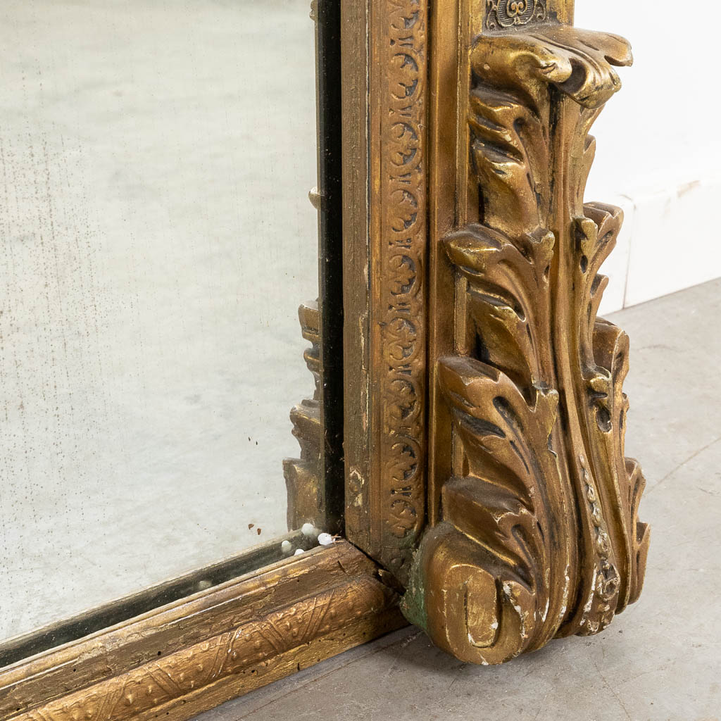 A large mirror, gilt and decorated with Kariatyds, circa 1900. (W:123 x H:220 cm)