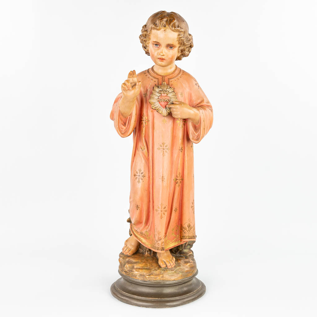 A statue made of patinated plaster 'Boy Jesus with Sacred Heart'. 