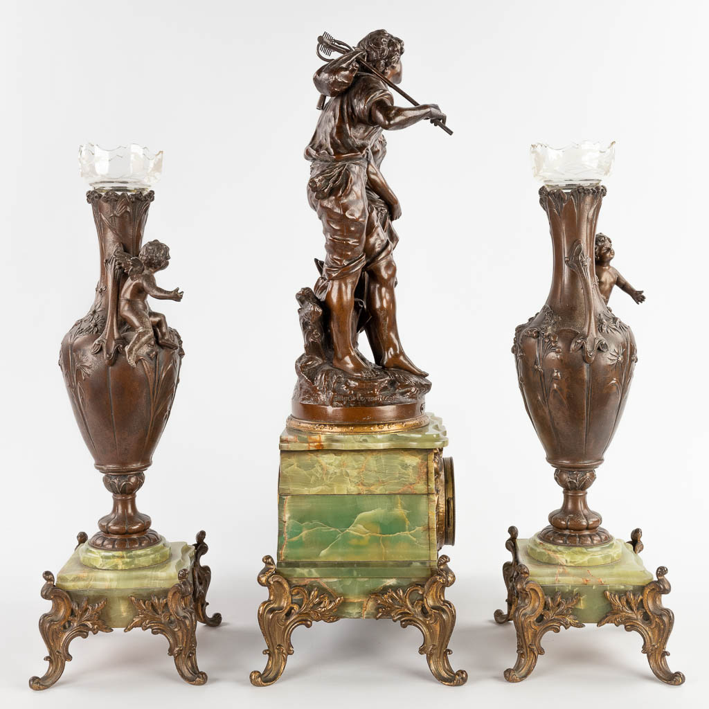 A three-piece mantle garniture clock with side pieces, spelter on an onyx base. 19th C. (D:20 x W:37 x H:64 cm)