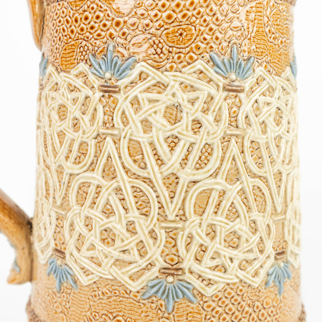 A pitcher made of stoneware and marked Doulton Lambeth Slaters, Royal Doulton. (H:23cm)
