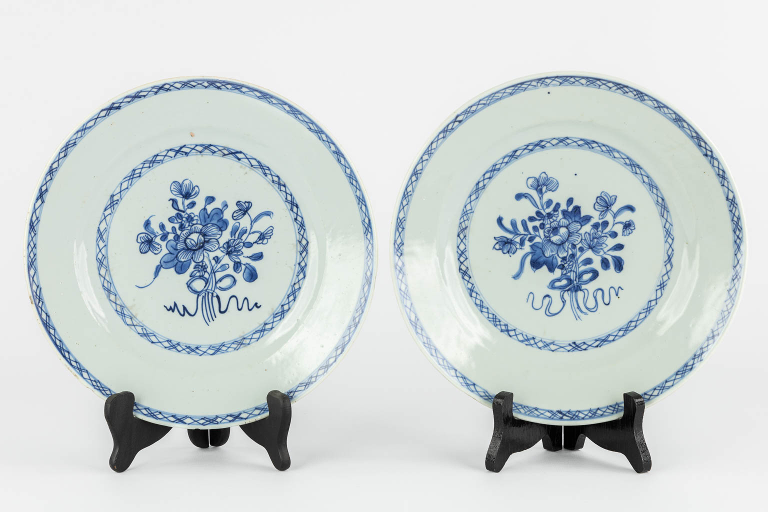 Four Chinese plates with a blue-white decor. (D:24 cm)