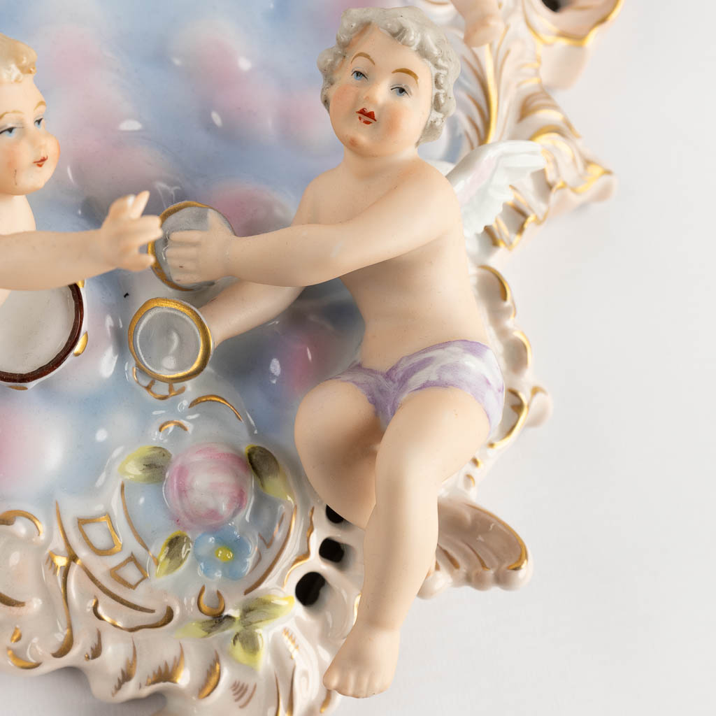 Dresden Porcelain, a pair of decorative wall plaques, decorated with musical putti. 20th C. (W:27 x H:33 cm)