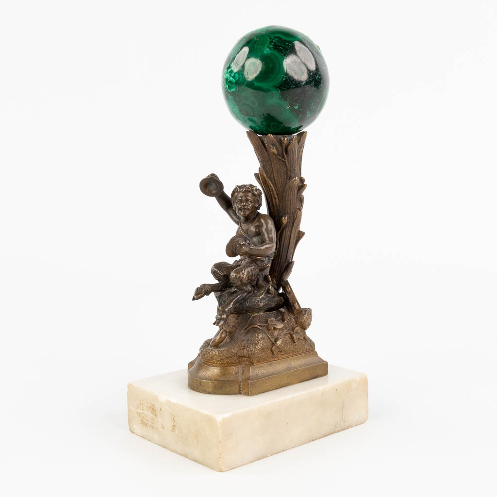  A musical Satyr figurine, probably a Vienna Bronze, with a large Malachite sphere on top.