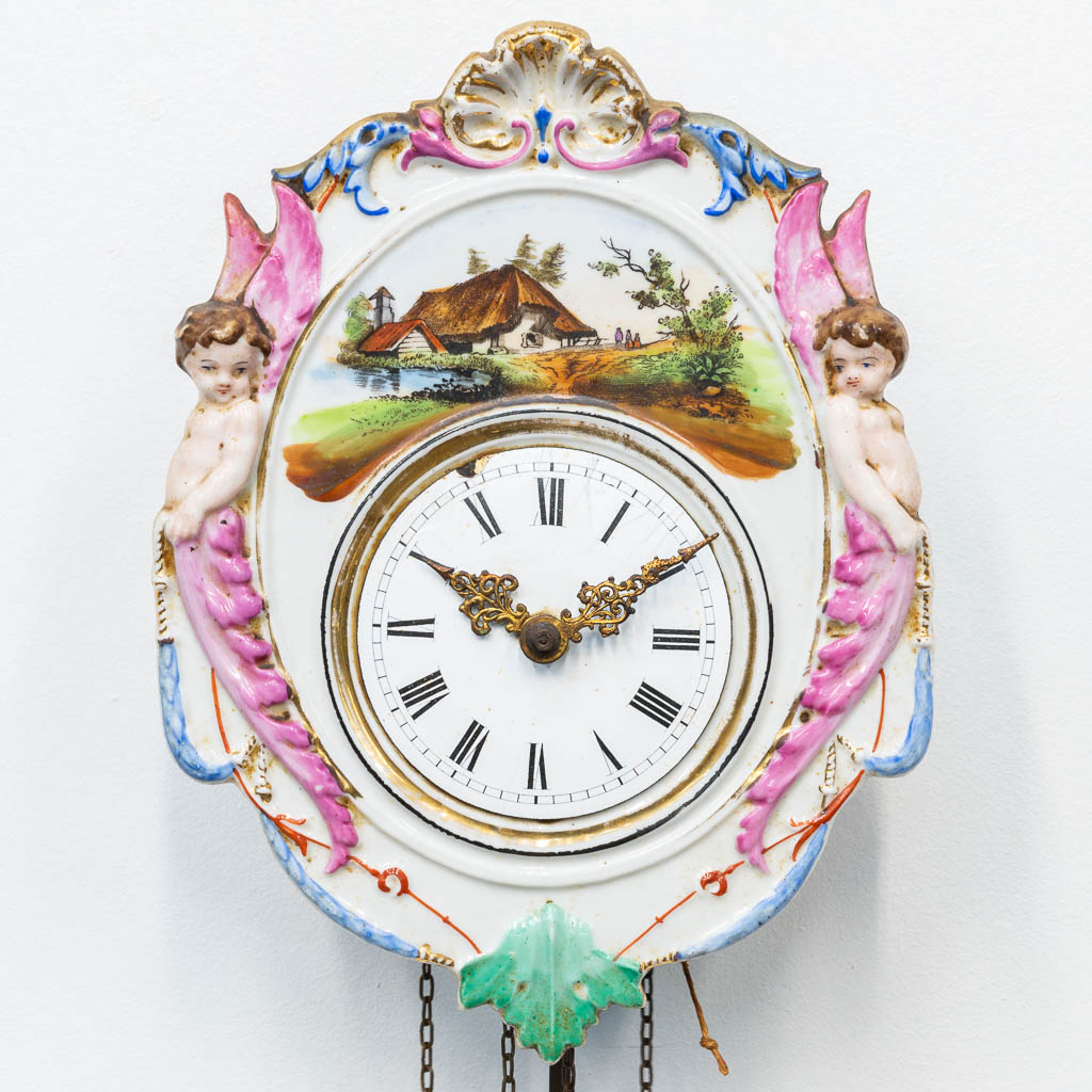 Een 'Jockele' klok gemaakt uit porselein met putti en handgeschilderd decor, Duitsland, 19de eeuw. 